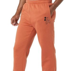 Orange sweatpants with Mickey Mouse on the pocket